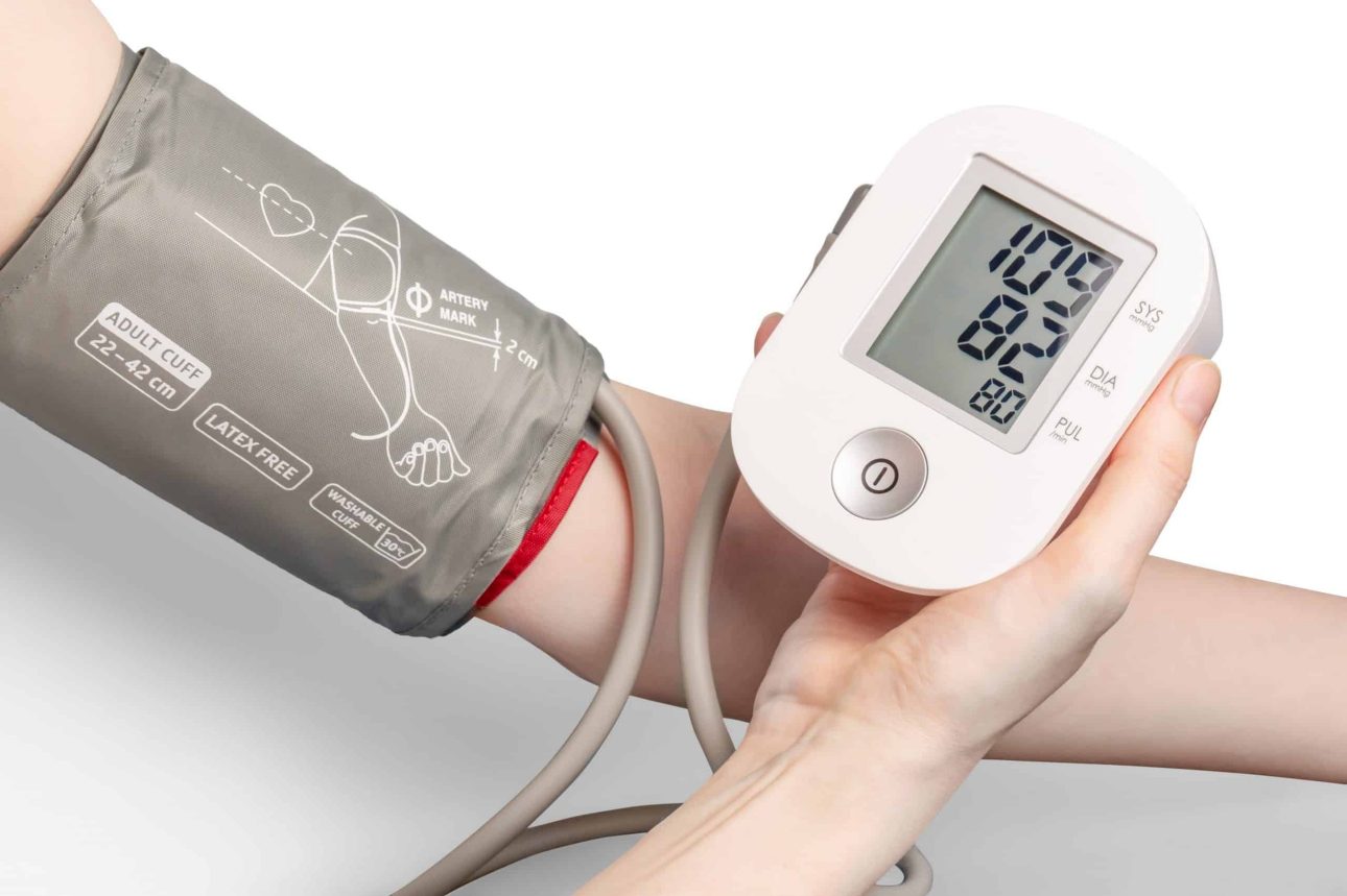 person using a blood pressure monitor with wrist cuff