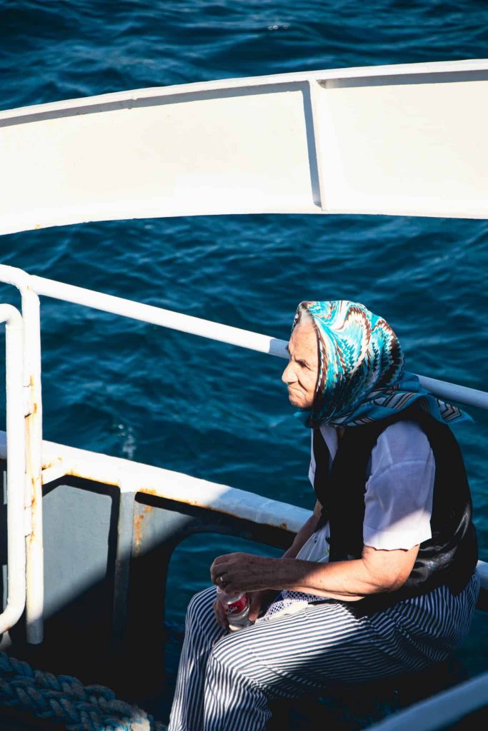 Elderly Woman Sitting on a Boat