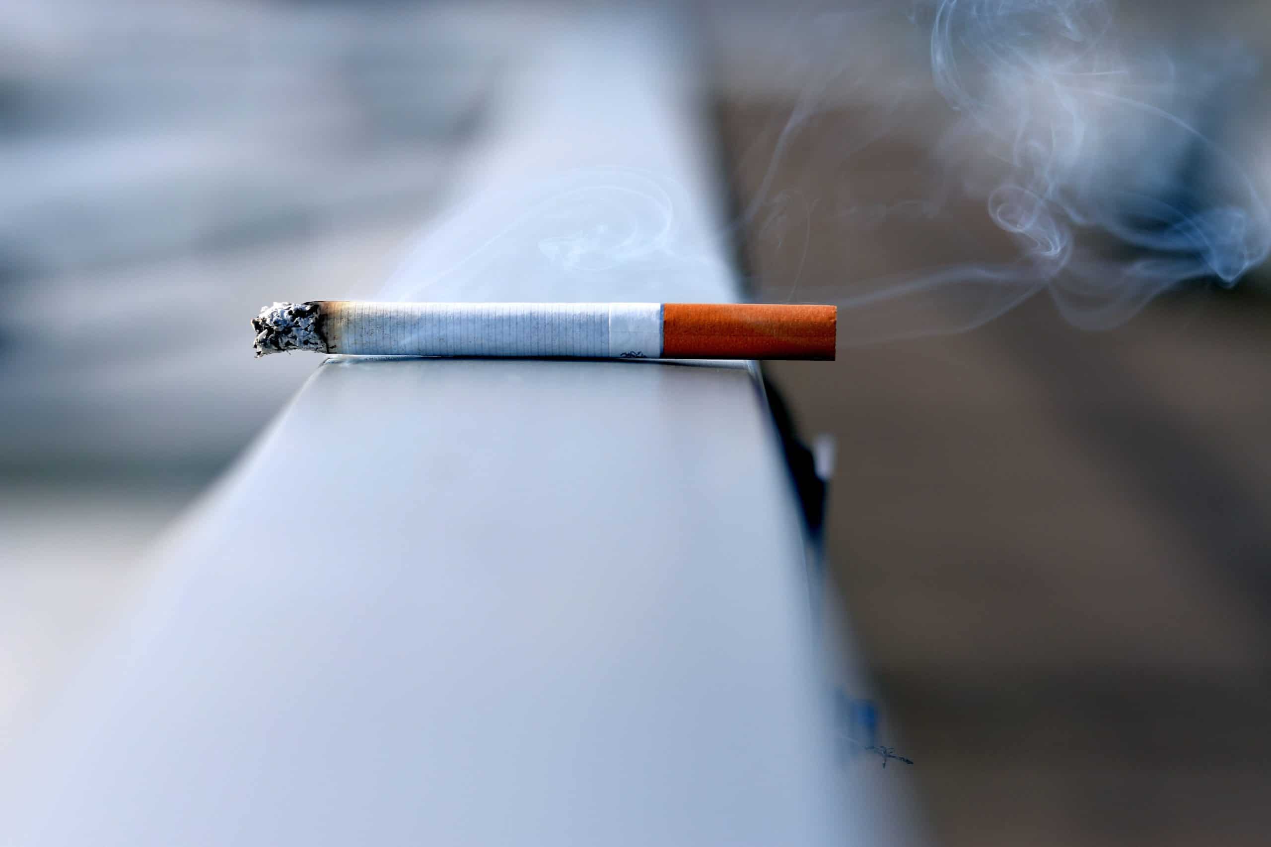 stick of cigarette on the edge of a building