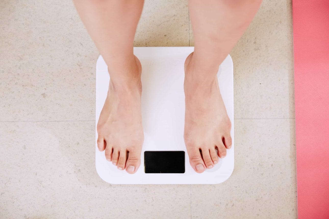 woman standing on a digital weighing scale