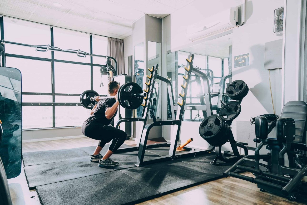 man lifting weights in a home gym