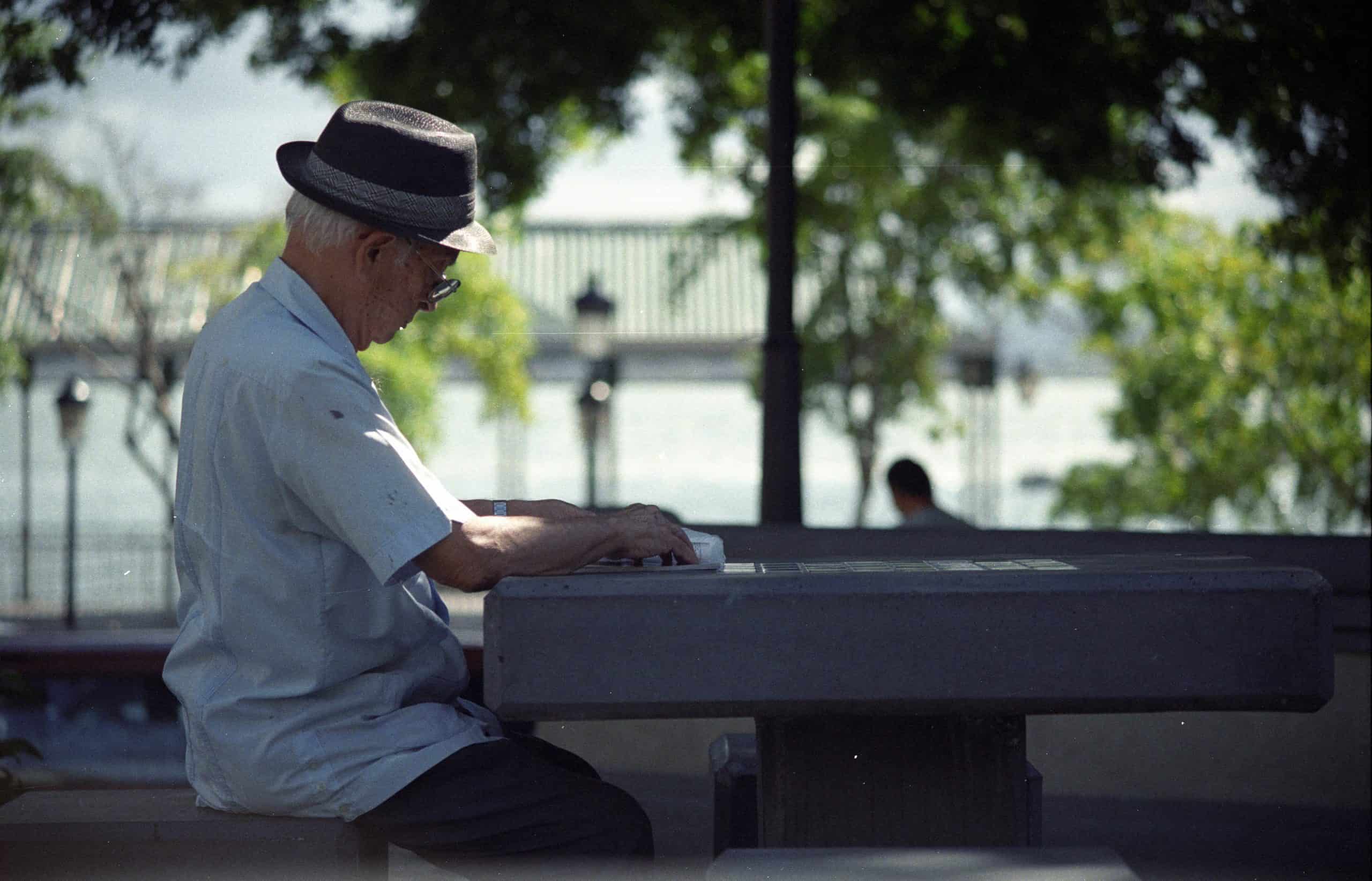 elderly asian man sitting on a char